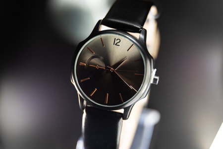 Wristwatch with black dial and stainless steel bracelet on black backgroundの写真素材