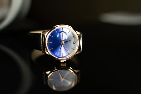 Wrist watch with blue dial on black background. close up.の写真素材