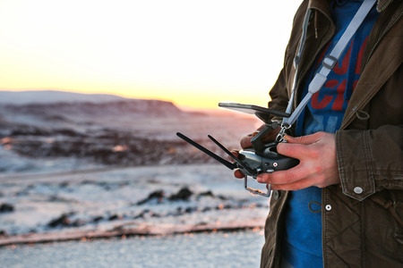 Black Drone remote controller transmitter in hands