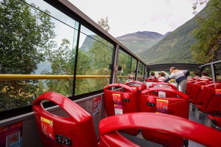 Tourist bus with red seats on the background of mountains in Norwayの写真素材
