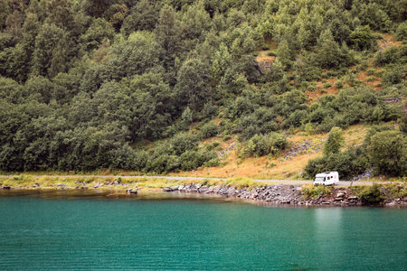 A motorhome on the shores of Geiranger fjord in Norway