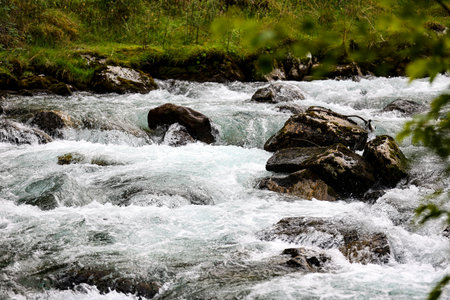 Fast mountain river with rapids and stones.