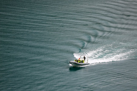 Aerial view of a motor boat sailing in the sea with white foamの写真素材