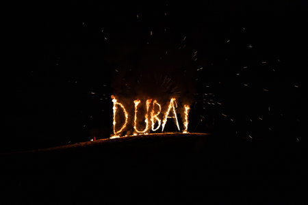 Fire lettering Dubai on black background at nightの写真素材