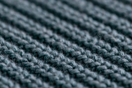 Turquoise knit wool fabric as a background. Wool knit texture. Knitted fabric surface with soft...