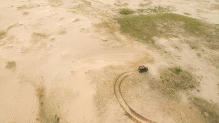 Machines drive through the desert from aboveの写真素材