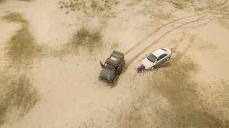 Machines drive through the desert from aboveの写真素材