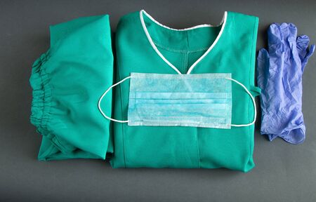 medical uniform set folded on isolated background nurse