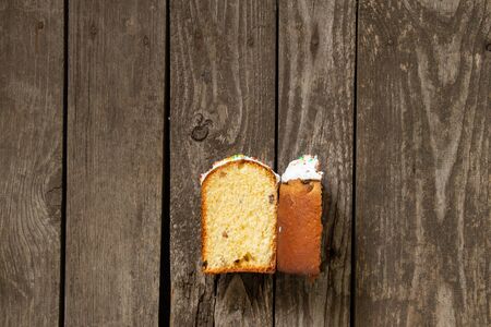 Easter cake cutted lies on an wooden board on Easter day
