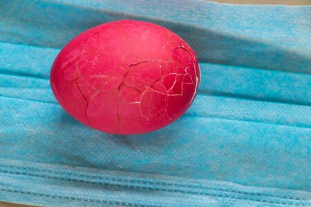 medical mask and on it lies an Easter egg for Easter duringの写真素材