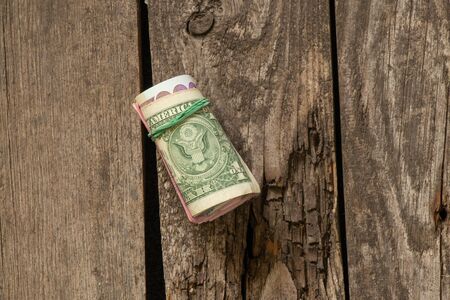 dollars into a roll on an isolated background