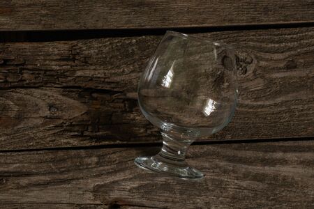 empty clean glass lies on an wooden tableの写真素材