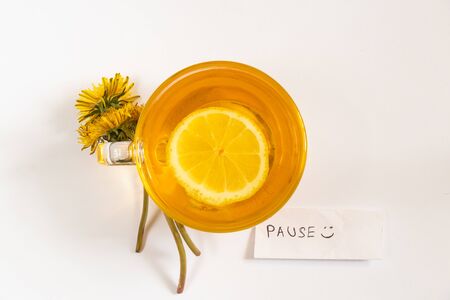 a cup of tea with lemon dandelions and the words in English good morningの写真素材