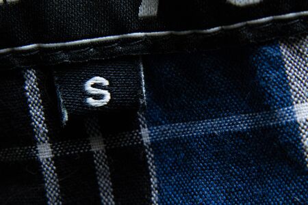 size s on a man s shirt as a backgroundの写真素材