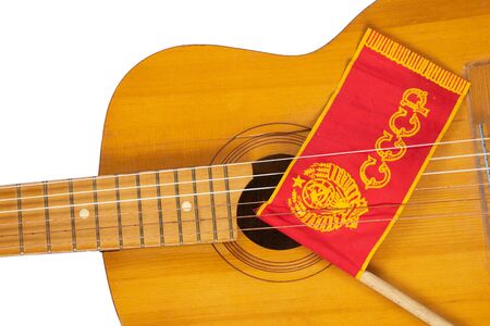Red USSR flag on a stick and an old guitar on a white background from Soviet timesの写真素材