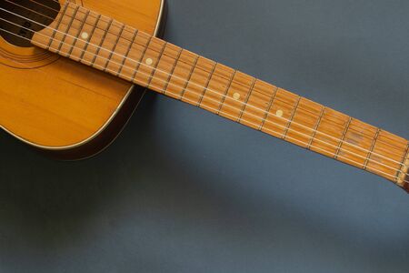 wooden brown guitar on a dark background