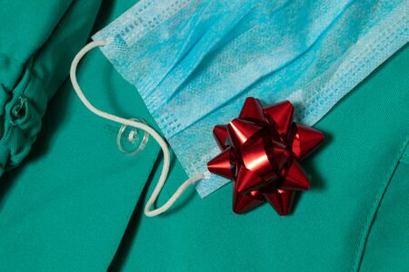of nurse work clothes in ukrainian hospital on isolated background close-up and red gift bowの写真素材