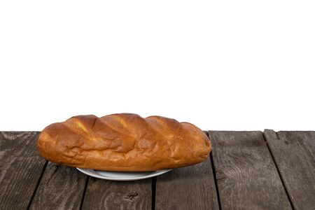 loaf of white bread on a plate on a table in the kitchenの写真素材