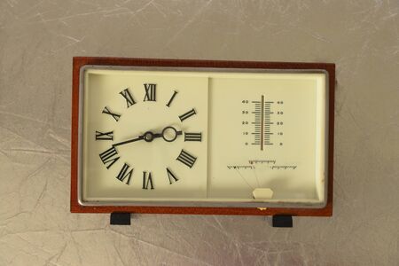 soviet table clock in a wooden frame lie on the table