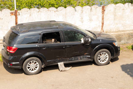 Ukraine, Dnipro - April 06, 2020. wrecked jeep dodge car stands on the street in the sun after an accidentのeditorial素材