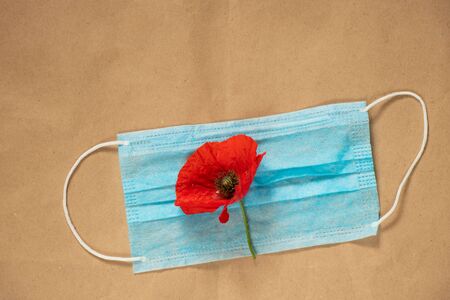 medical mask and poppy flower on the tableの写真素材
