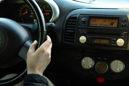 hands on the steering wheel inside the car in the afternoonの写真素材