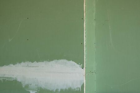 drywall wall of green color as a backgroundの写真素材
