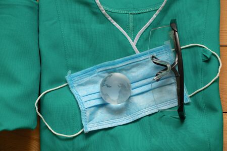 set of medical uniform and glass globe on an isolated backgroundの写真素材