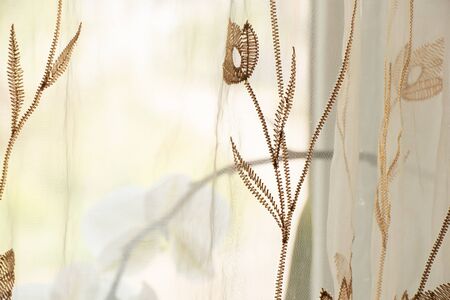 curtains with embroidered flowers as a background
