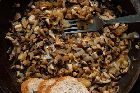 fried mushrooms in pans on a table in the kitchen on a tableの写真素材
