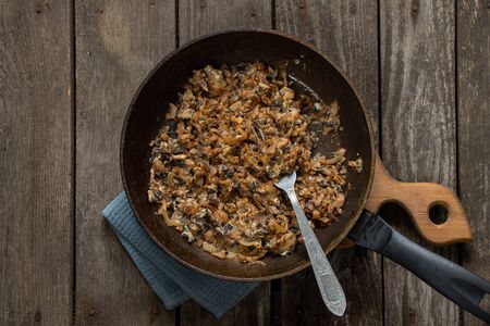 fried mushrooms in pans on a table in the kitchen on a tableの写真素材