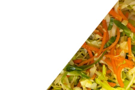 salad with fresh cabbage and carrots as a background close-upの写真素材