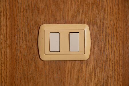 light switch on a wooden wallの写真素材