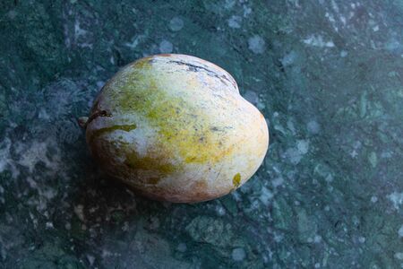 ripe mango close-up lies on the tableの写真素材