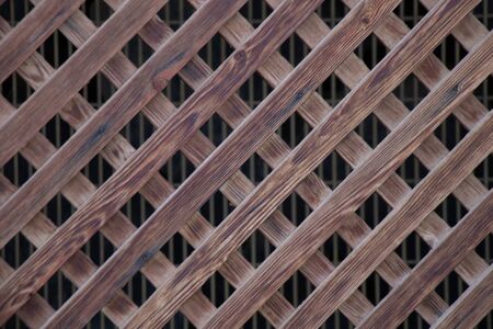 wooden fence with diagonal boards as a backgroundの写真素材