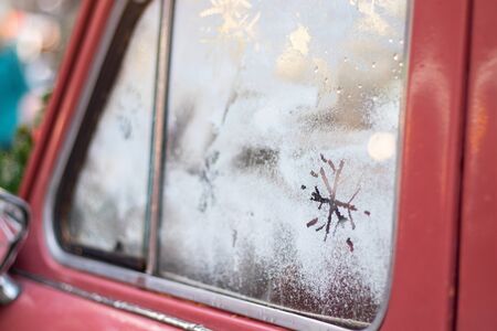 snowflake on the glass of an old car, new year holidayの写真素材