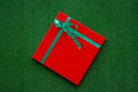 red gift box on a green backgroundの写真素材