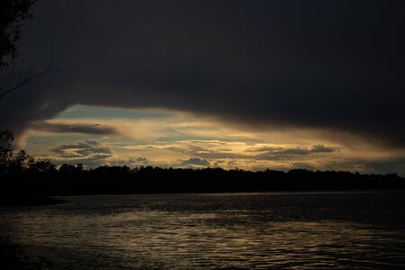 thunderclouds at sunset over the Dnieper riverの写真素材