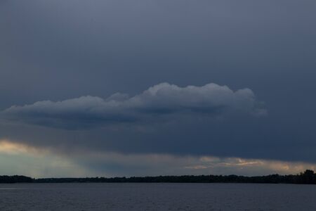 thunderclouds at sunset over the Dnieper riverの写真素材