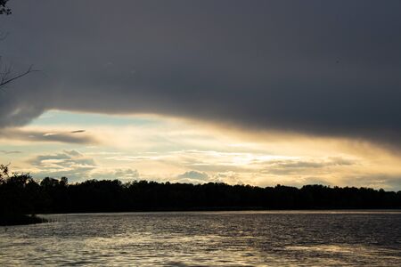 thunderclouds at sunset over the Dnieper riverの写真素材