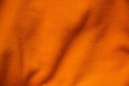 soft orange crumpled fabric as backgroundの写真素材