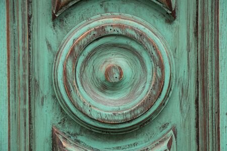 green painted wooden wall with a circle cut out in the center as a backgroundの写真素材
