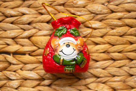 glass Christmas toy on a straw backgroundの写真素材