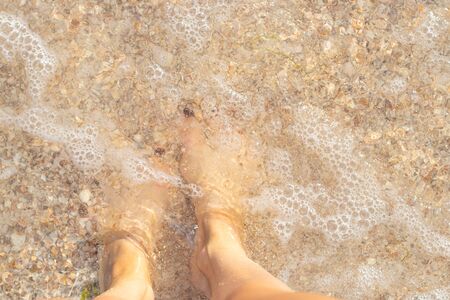 female legs in sea water top viewの写真素材