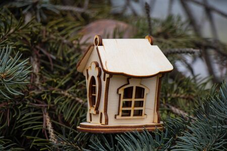 small wooden house on the branches of a Christmas treeの写真素材