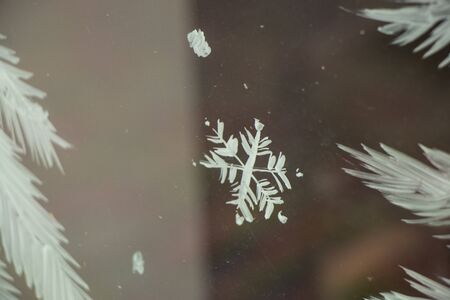 painted snowflake on a window in winter