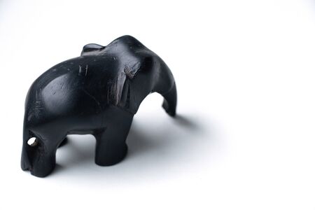 handmade stone elephant figurine on an isolated whiteの写真素材