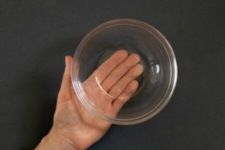 empty empty plate in the hands of a girl on an isolated background