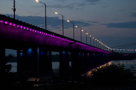 Old bridge in the evening with backlight in the city of Dnieperの写真素材