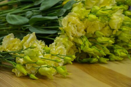 a bouquet of lisianthus flowers lies on the tableの写真素材